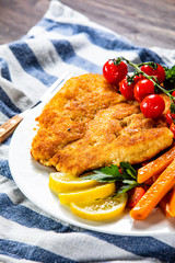 Fried pork chop, French fries and vegetable salad