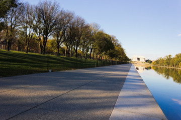 Autumnal vista looking westwards along the ceremonial tree-lined boulevard of the National Mall towards the historic Lincoln Memorial