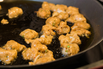 Fried Squid-Cake Is snacks, that brought the fish mixed with squid, kaffir lime leaves, green beans, chili and curry and spinning water nodular, fry until cooked and served with a sauce