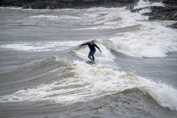 middle aged surf holds the wave