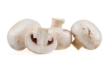 Fresh composition of whole and sliced champignon mushrooms on a neutral white background