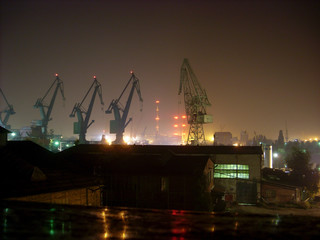 A night photograph of the Gdańsk Shipyard.