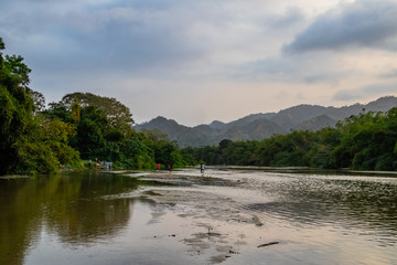local people swimming in a river in the rainforest of south america