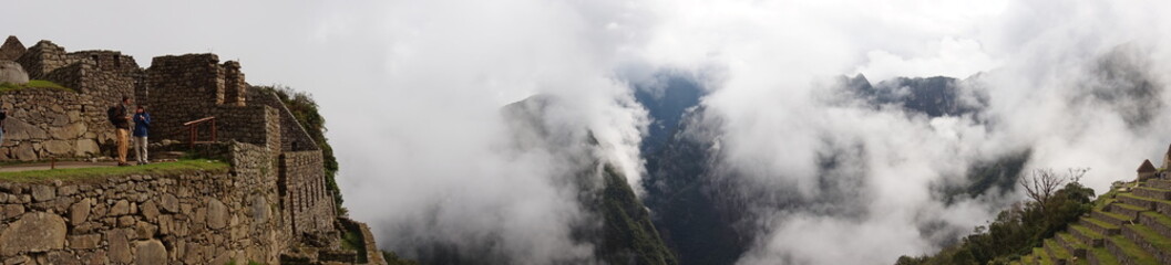 fog over machu picchu inca ruins in peru