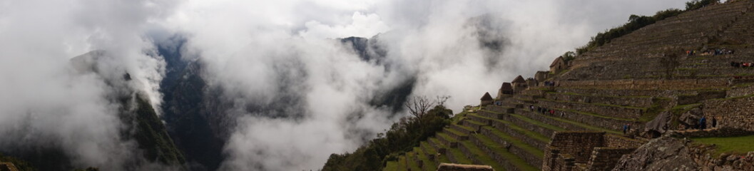 fog over machu picchu inca ruins in peru