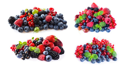 Berries and fruits isolated on white background. Ripe blueberries, blackberries, blackcurrants, raspberries, gooseberries, strawberries and red currants. Mix berries with copy space for text.