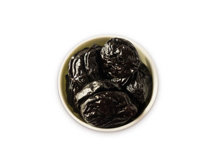 Dried prunes isolated on a white background. Dried prunes in a bowl on white background. Dried prunes with copy space for text. Top view