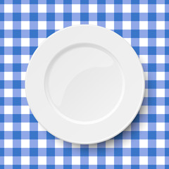 Close up view of empty white dish placed on classic checkered blue tablecloth seamless background. View from above.