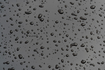 Drops of water on a black iron floor for background and textured.