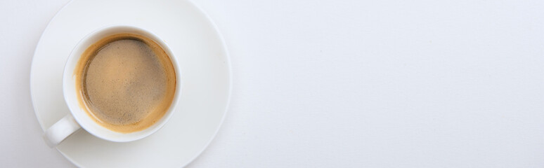 panoramic shot of cup with delicious hot coffee on white background