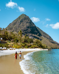 couple on vacation in St Lucia, men and woman walking on the beach Saint Lucia - obrazy, fototapety, plakaty