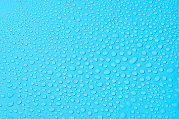 different water drops on blue background, close up