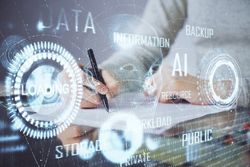 Double exposure of writing hand on background with data technology hologram. Big data concept.
