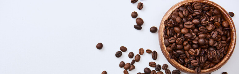 panoramic shot of tasty coffee roasted beans in wooden bowl on white background with copy space