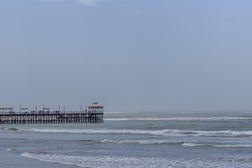 surfing beach with pier in huanchaco, peru