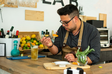 Barman in pub or restaurant preparing a gin tonic cocktail