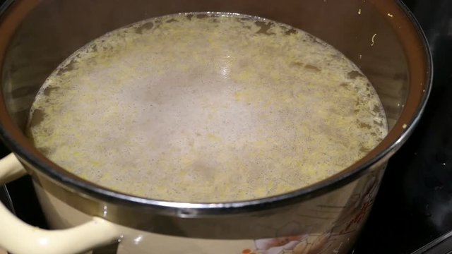 Cooking elder beery flower head jam confiture in a pot.