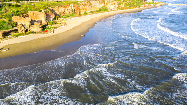 Aerial view of the free beach of the Nerone caves next to the Imperial Villa of Anzio in Italy. Here are the ruins of the emperor's villa of ancient Rome.