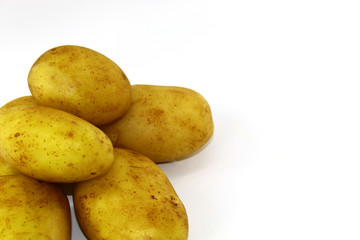 Washed with water fresh and young potatoes on a light background