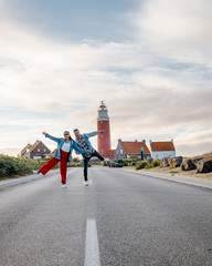 couple lighthouse Texel Netherlands, men and woman on vacation Dutch Island texel