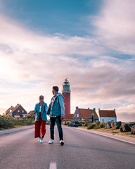 couple lighthouse Texel Netherlands, men and woman on vacation Dutch Island texel