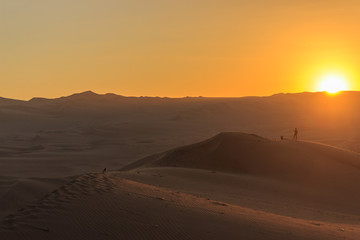 sunset at huacachina desert oasis in peru