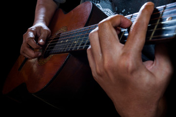Close-up of a man playing the guitar