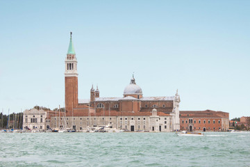 Fototapeta premium The island of San Giorgio Maggiore and the eponymous cathedral. Yacht club on an island on the shore of the Venetian lagoon. Religion, Christianity and Catholic cathedral, ancient architecture.