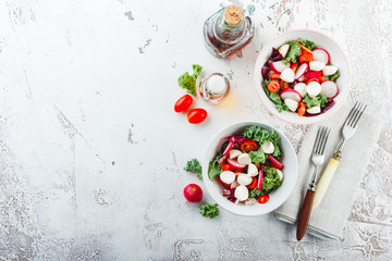 Salad with cherry tomatoes, radsh and mozzarella, lettuce mix