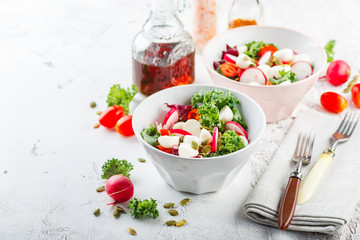 Salad with cherry tomatoes, radsh and mozzarella, lettuce mix