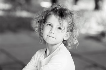 Portrait of a little curly girl.