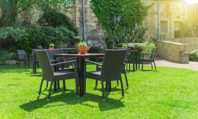 Fototapeta na wymiar Chairs and tables set up in the garden for the simmer time in the UK.