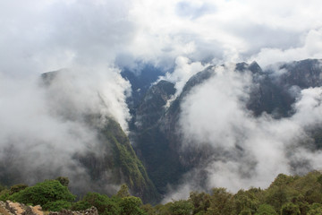 fog over machu picchu inca ruins in peru