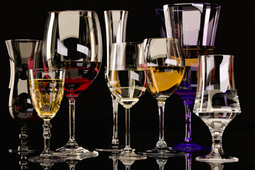 Strong alcoholic beverages, glasses and glasses, in the presence of whiskey, vodka, rum, tequila, brandy, cognac. on dark old background with selective focus