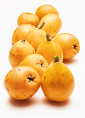 Fresh loquats (medlars). Isolated on white background. Close-up.