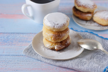 Curd cheesecakes on a white plate sprinkled with powdered sugar. Delicious dessert.