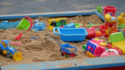 Children's Sandbox. Set Of Colored Plastic Toys On The Sand, 