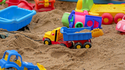 Children's Sandbox. Set Of Colored Plastic Toys On The Sand, 