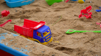 Children's Sandbox. Set Of Colored Plastic Toys On The Sand, 