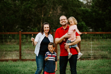 Fototapeta premium Happy family playing with sparkler fireworks together