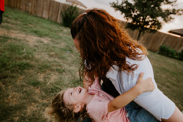 Happy mother playing with son