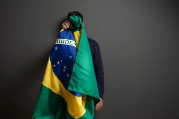Papier Peint photo Lavable Brésil Men with brazilian flag and depression