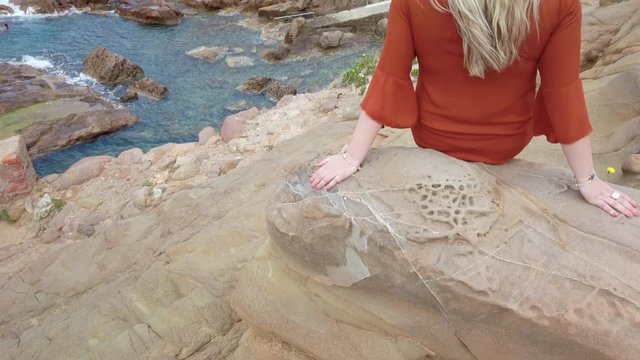Blonde girl admires Cliffs of the Tuscan coast Castle of Boccale Livorno Leghorn