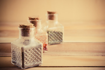 jars of spices on a wooden background