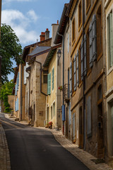 Fototapeta na wymiar CLUNY / FRANCE - JULY 2015: Quiet street in the historic centre of Cluny town, France