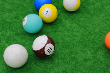 balls with numbers on a green field