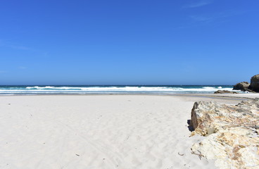 Wild beach with white sand, rocks and waves. Lugo, Spain.