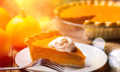 Tasty pumpkin pie on background