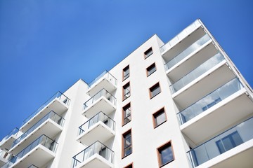Fototapeta premium Modern apartment buildings on a sunny day with a blue sky. Facade of a modern apartment building