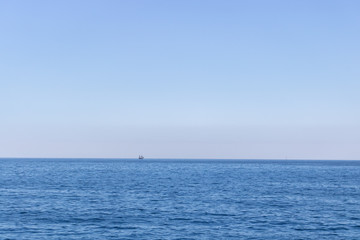 Obraz premium Seascape with sea horizon and almost clear deep blue sky